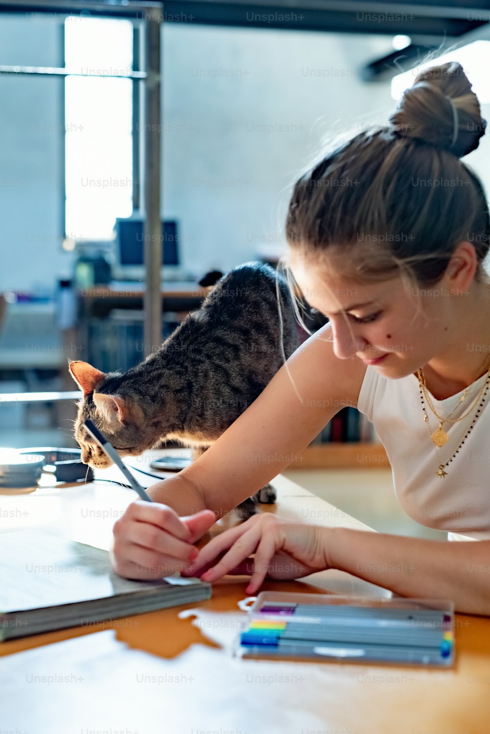 a young girl is playing with a cat