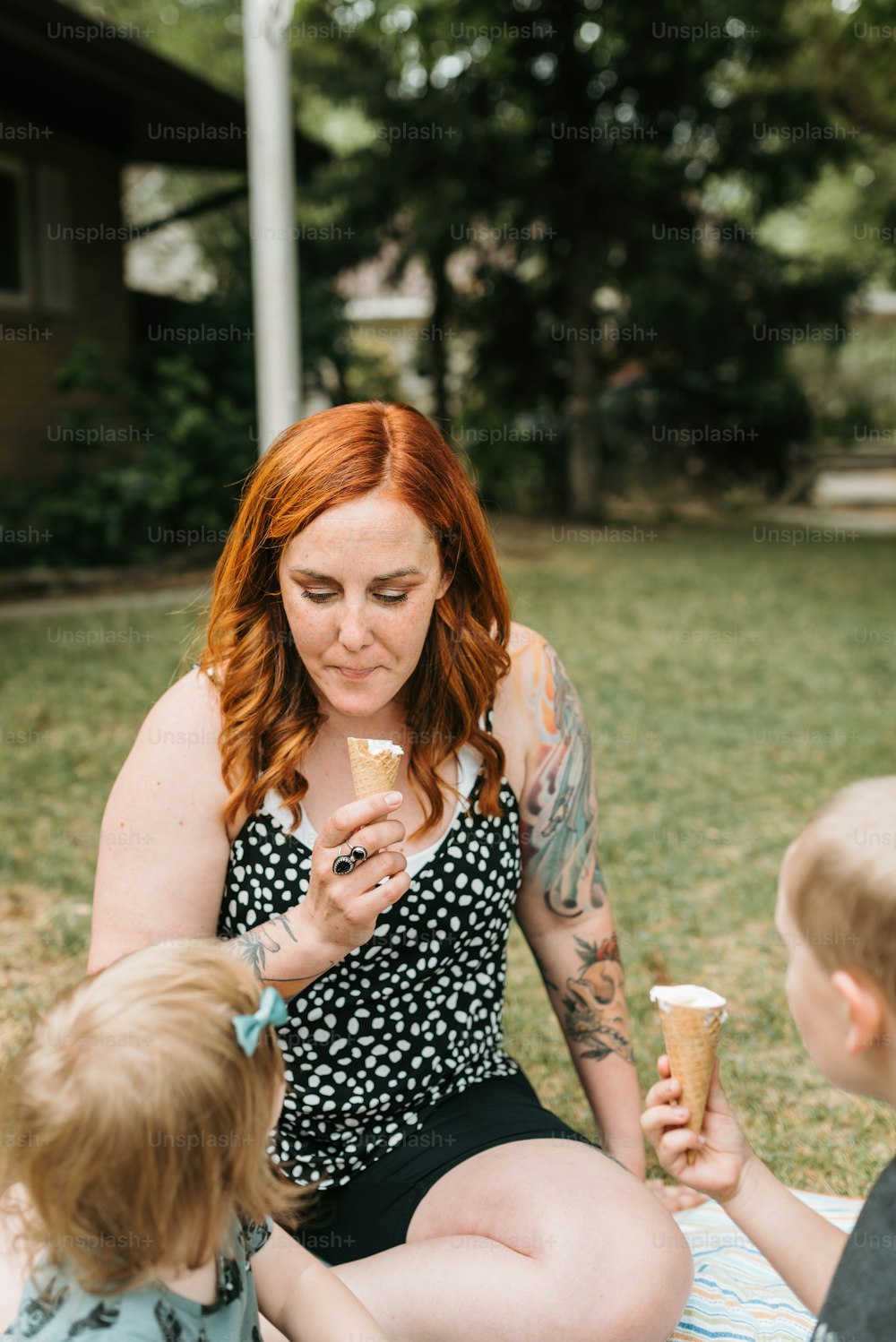 a woman and two children eating ice cream