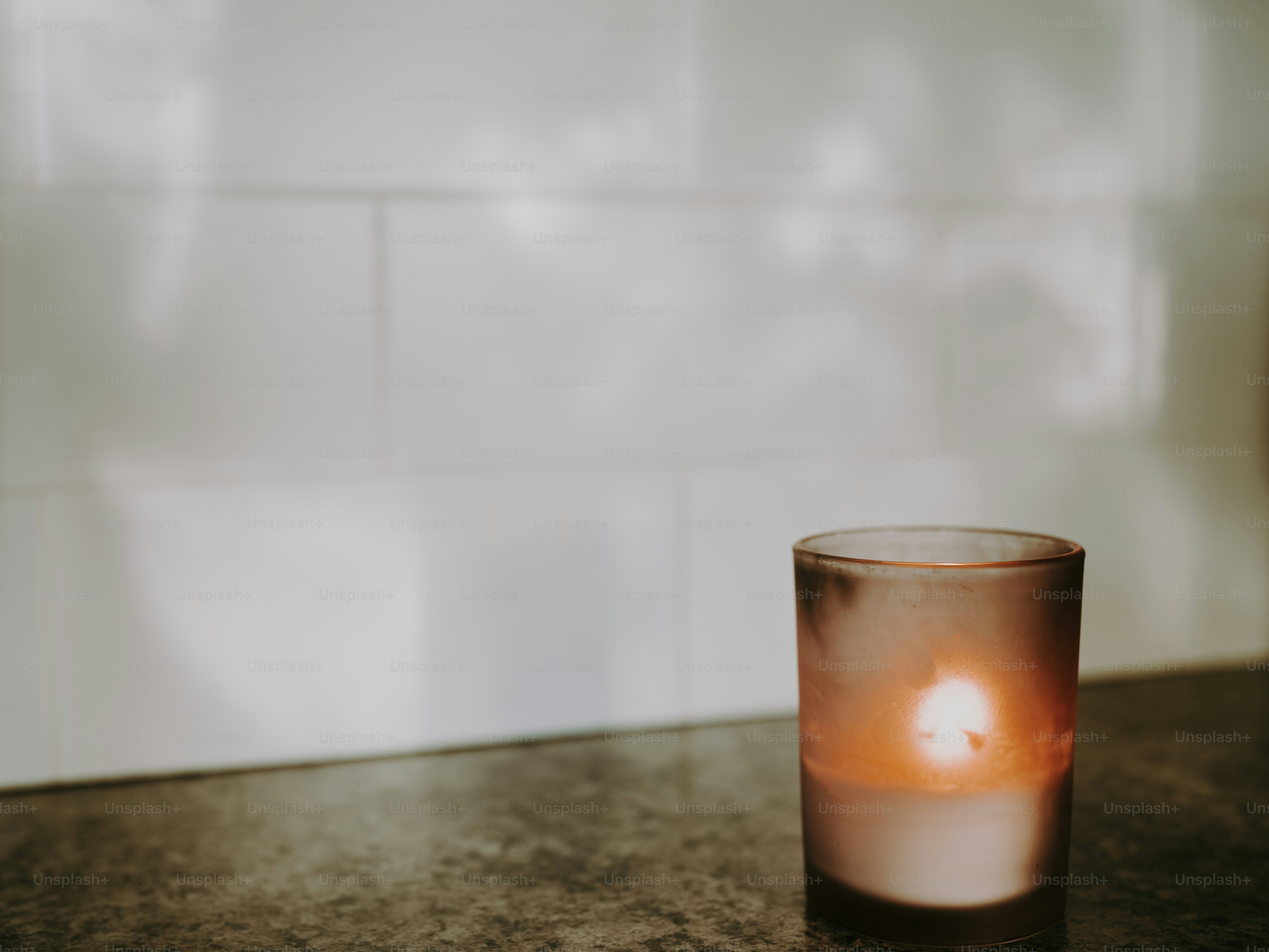 a lit candle sitting on top of a table