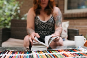 a woman sitting on a couch reading a book