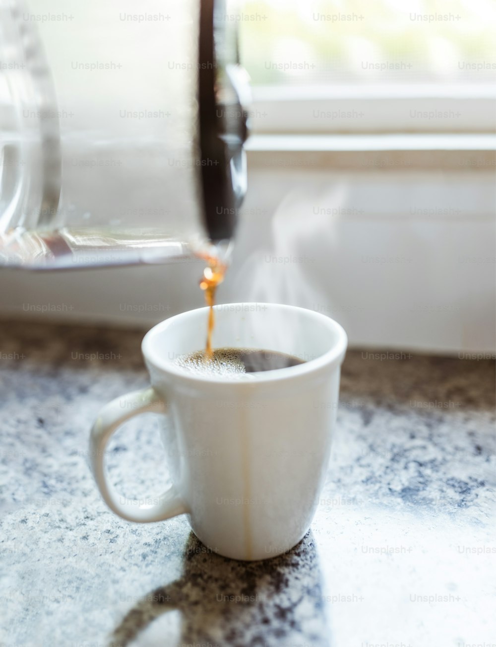 a cup of coffee being poured into it