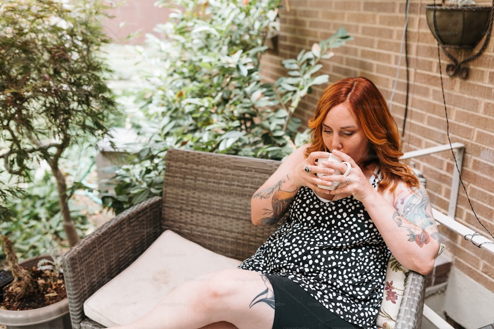 a woman sitting on a bench with a tattoo on her arm