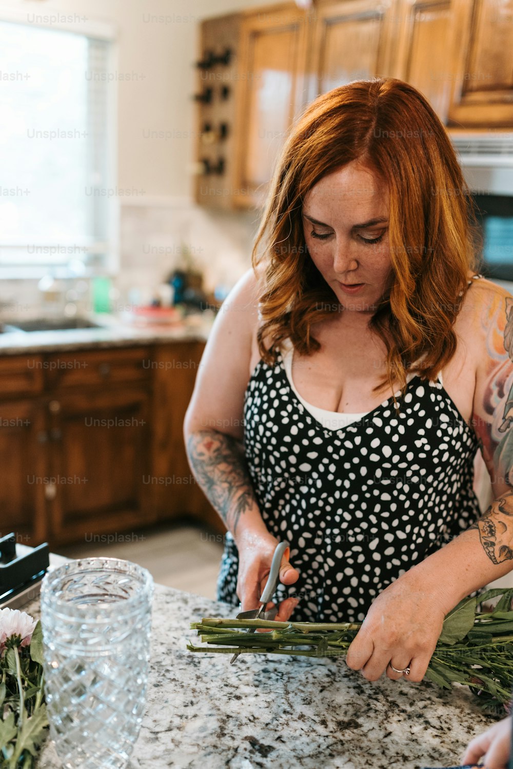 a woman in a black and white top cutting flowers