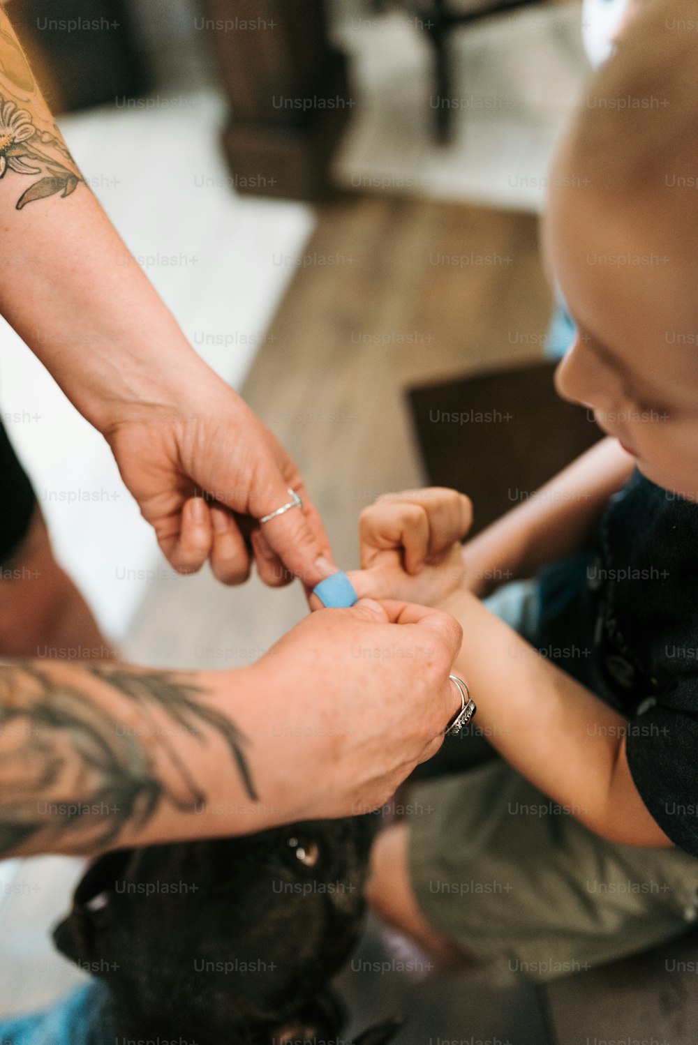 a woman putting a ring on a small child's finger