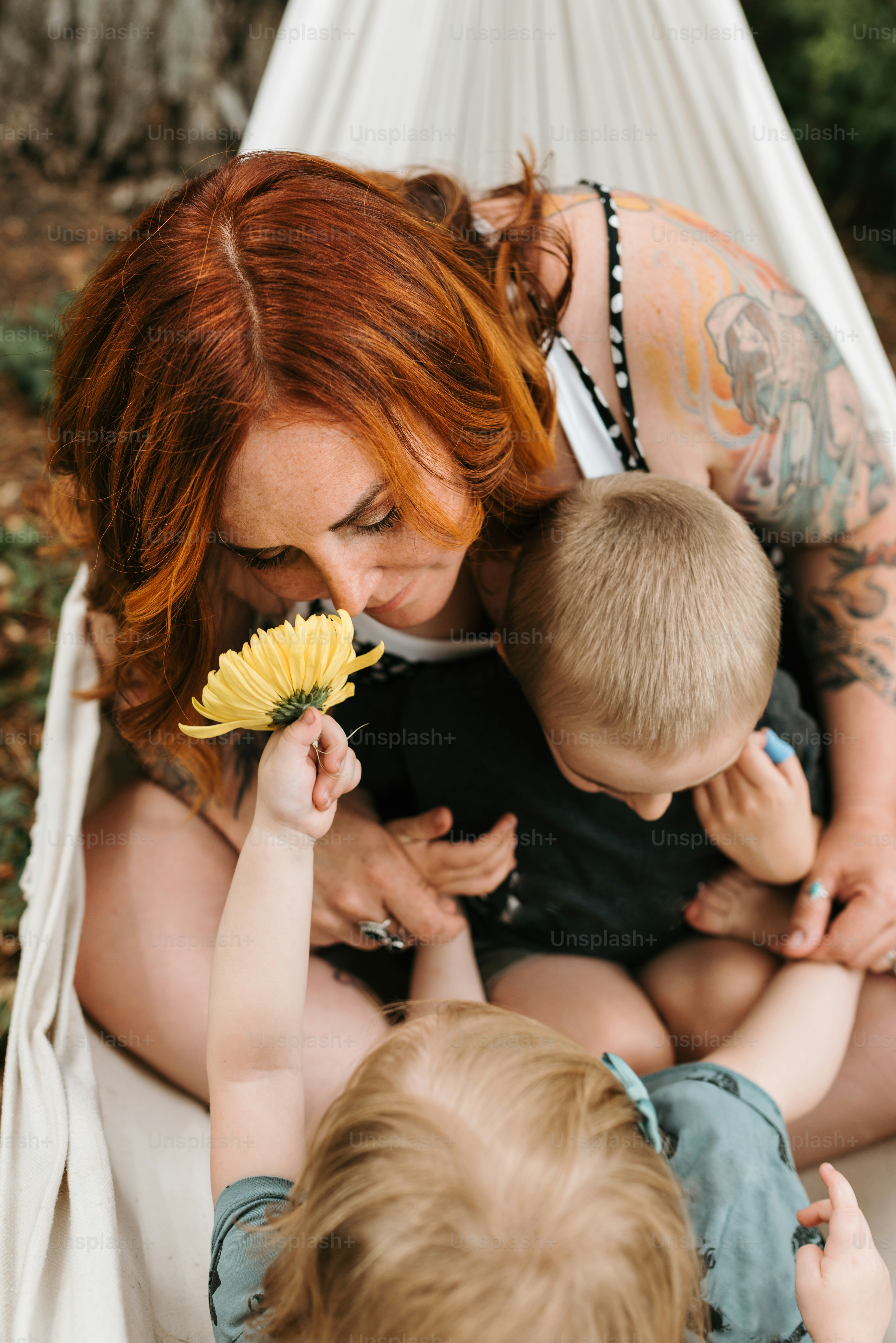 a woman holding a baby and holding a flower