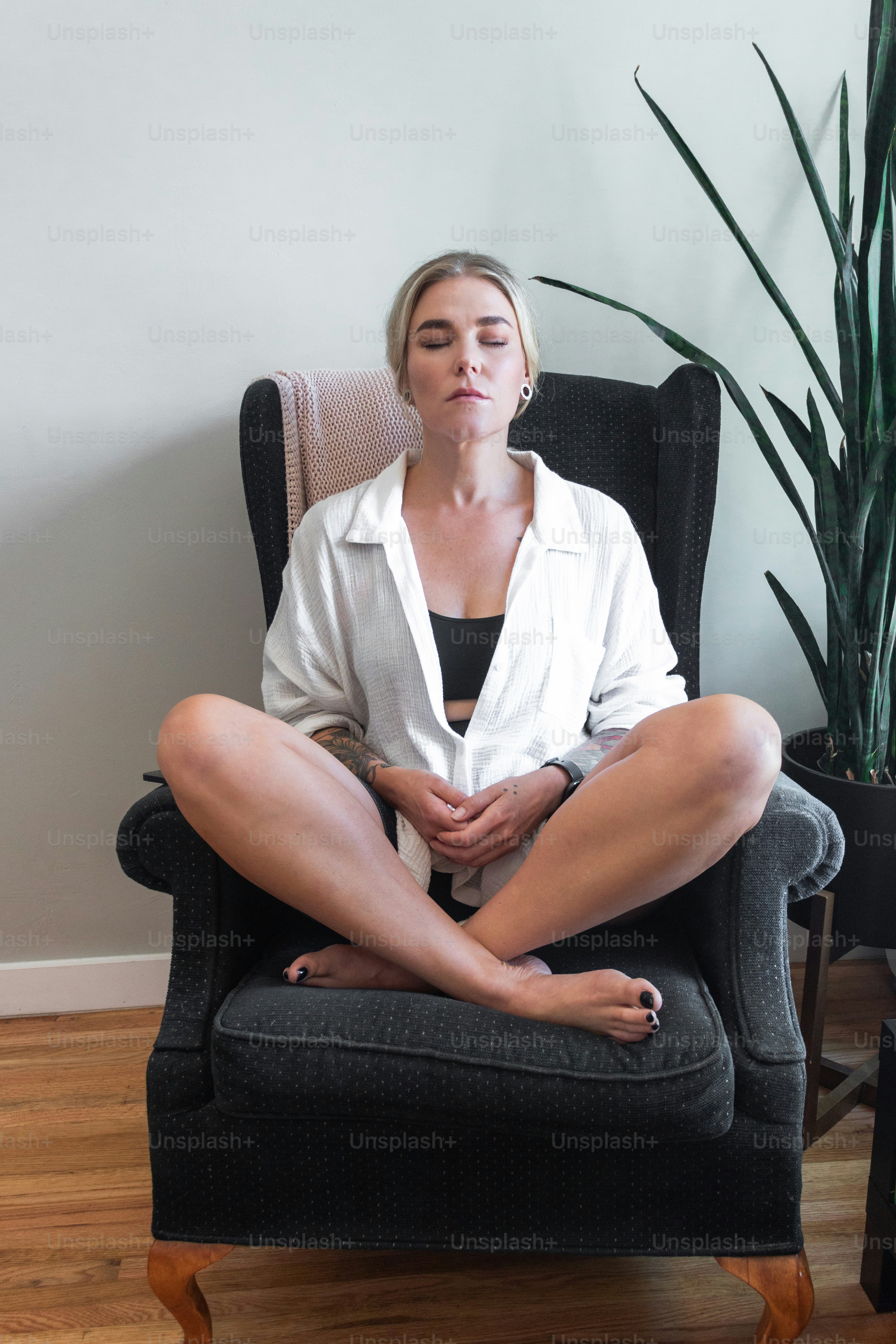 a woman sitting in a chair with her eyes closed