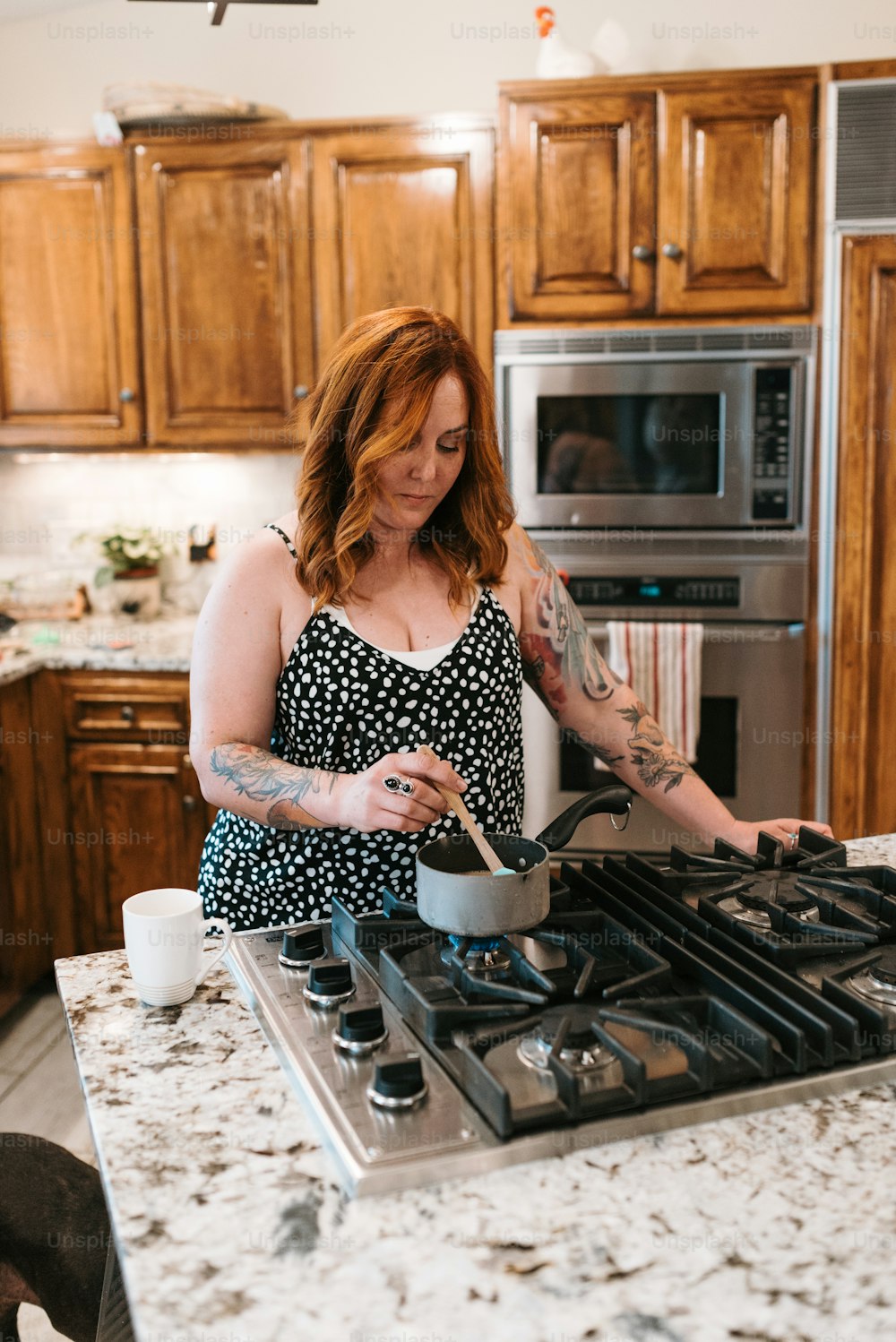 a woman in a kitchen preparing food on a stove