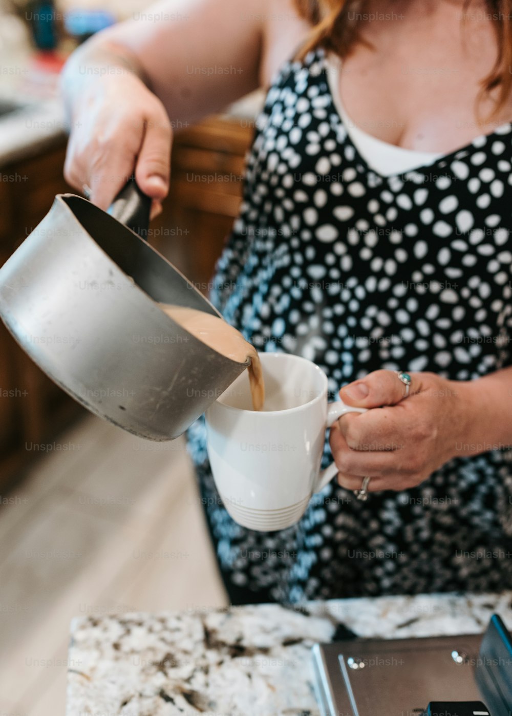 a woman pours coffee into a cup