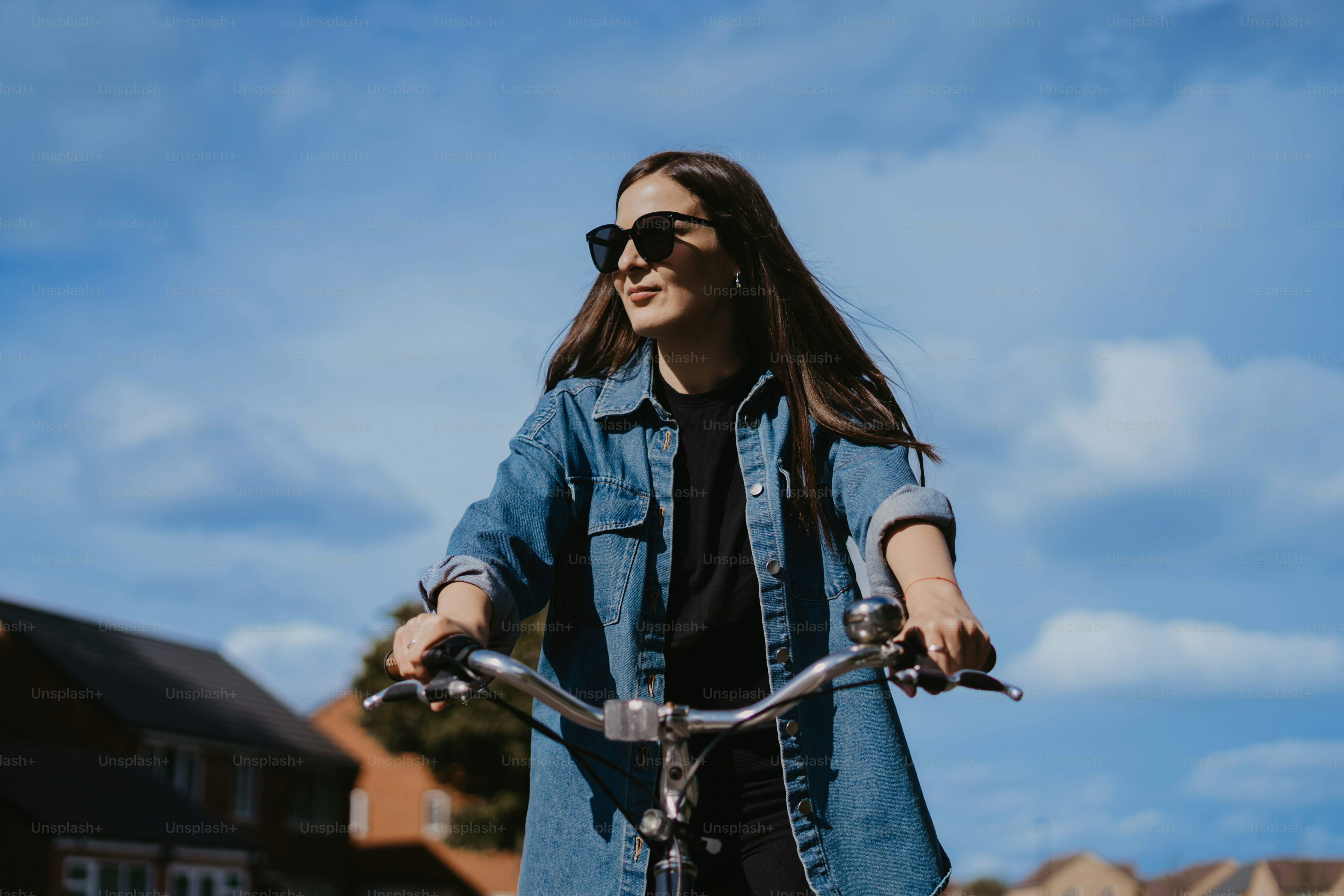 a woman riding a bike down a street