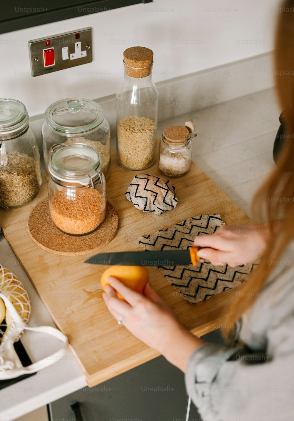 a woman is cutting up some food on a cutting board