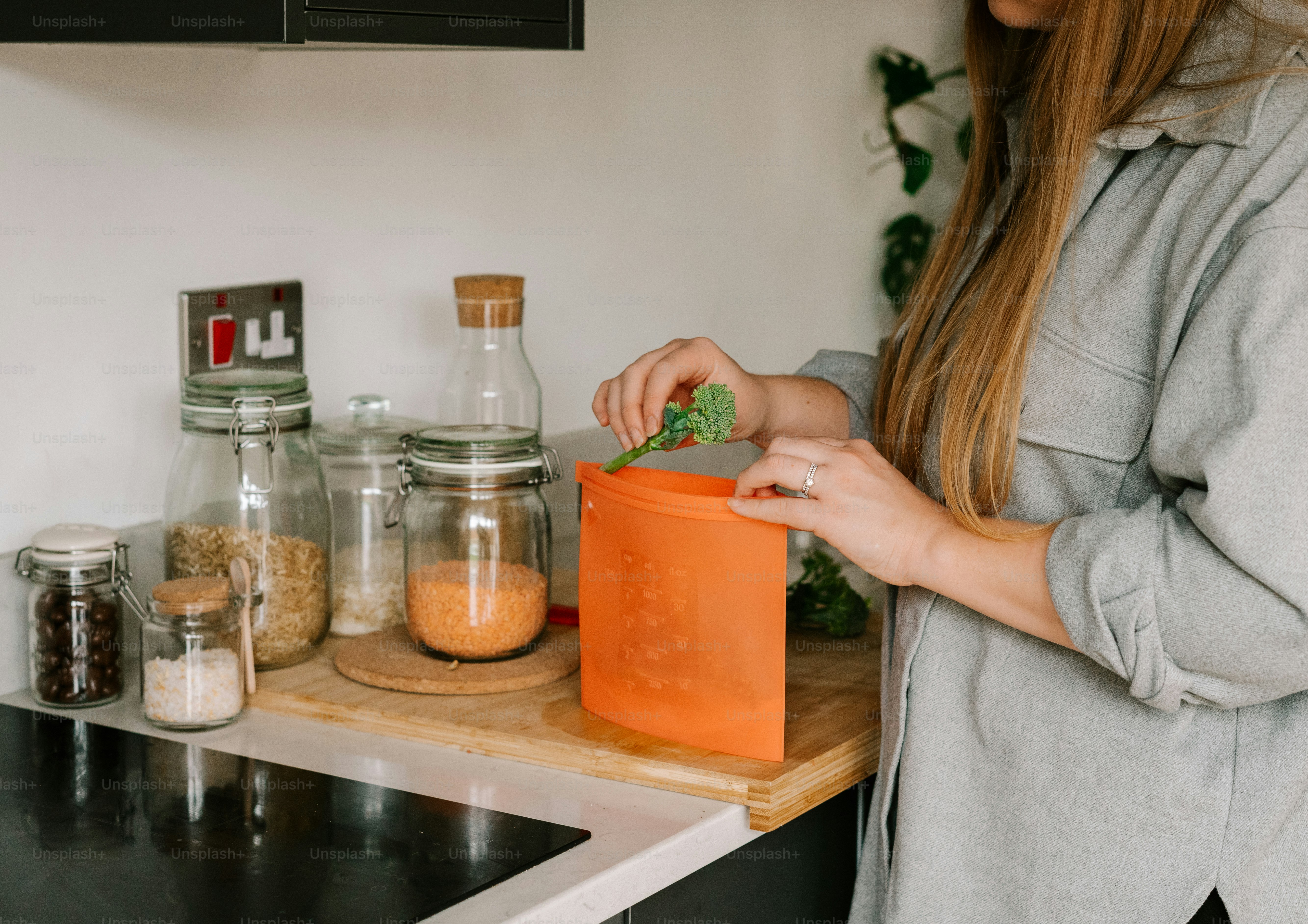 a woman standing in a kitchen preparing food