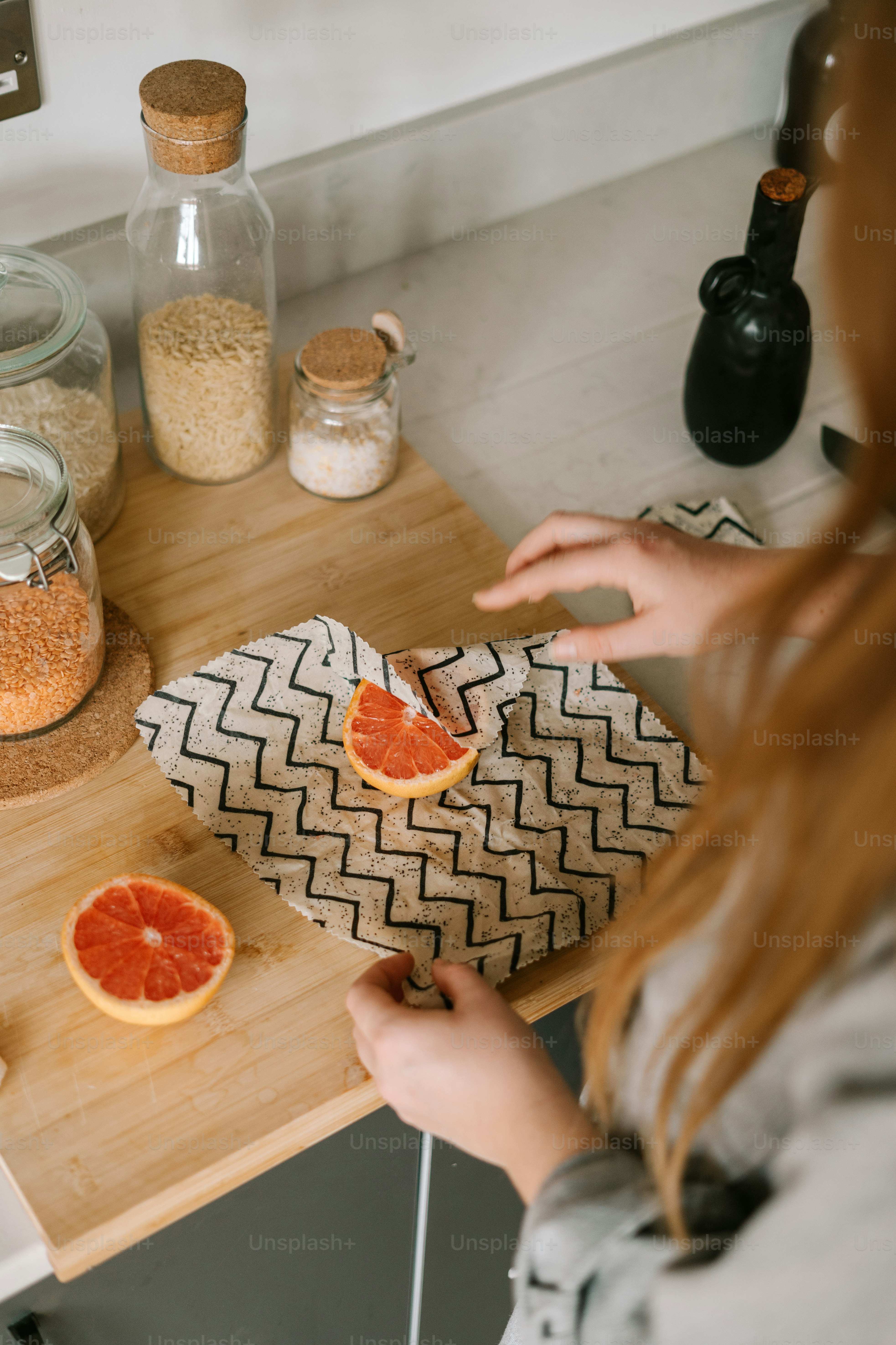 a woman cutting up oranges on a cutting board