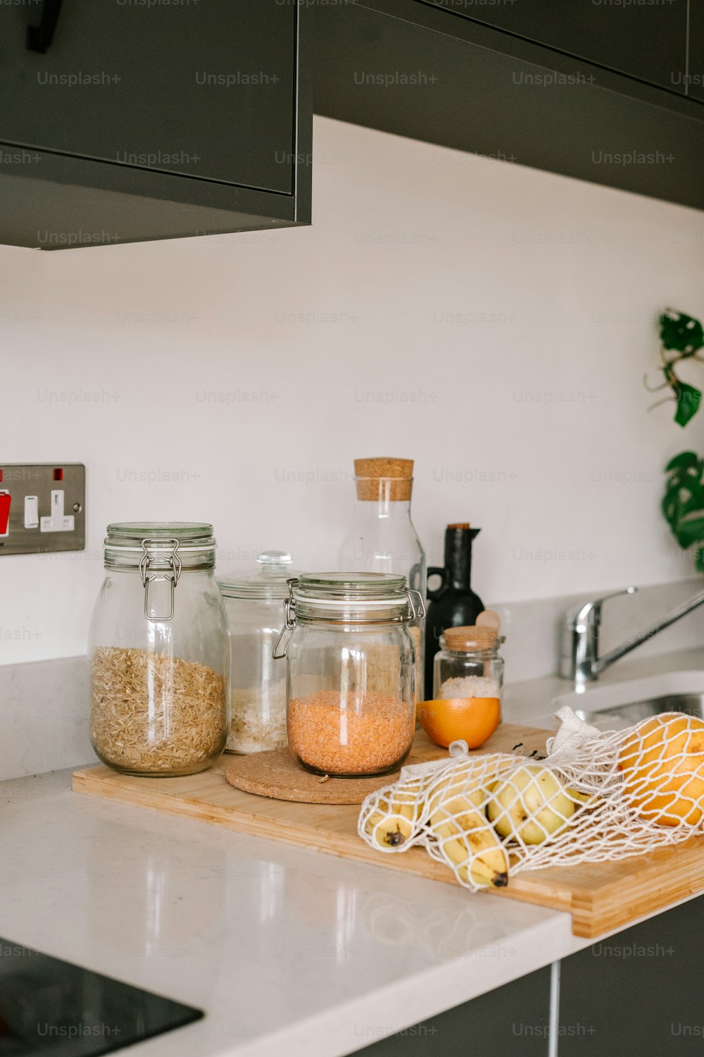 a kitchen counter topped with jars filled with food