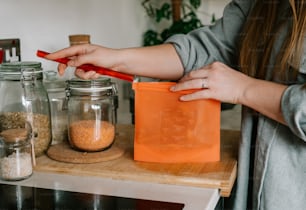 a woman is holding a plastic bag over a counter