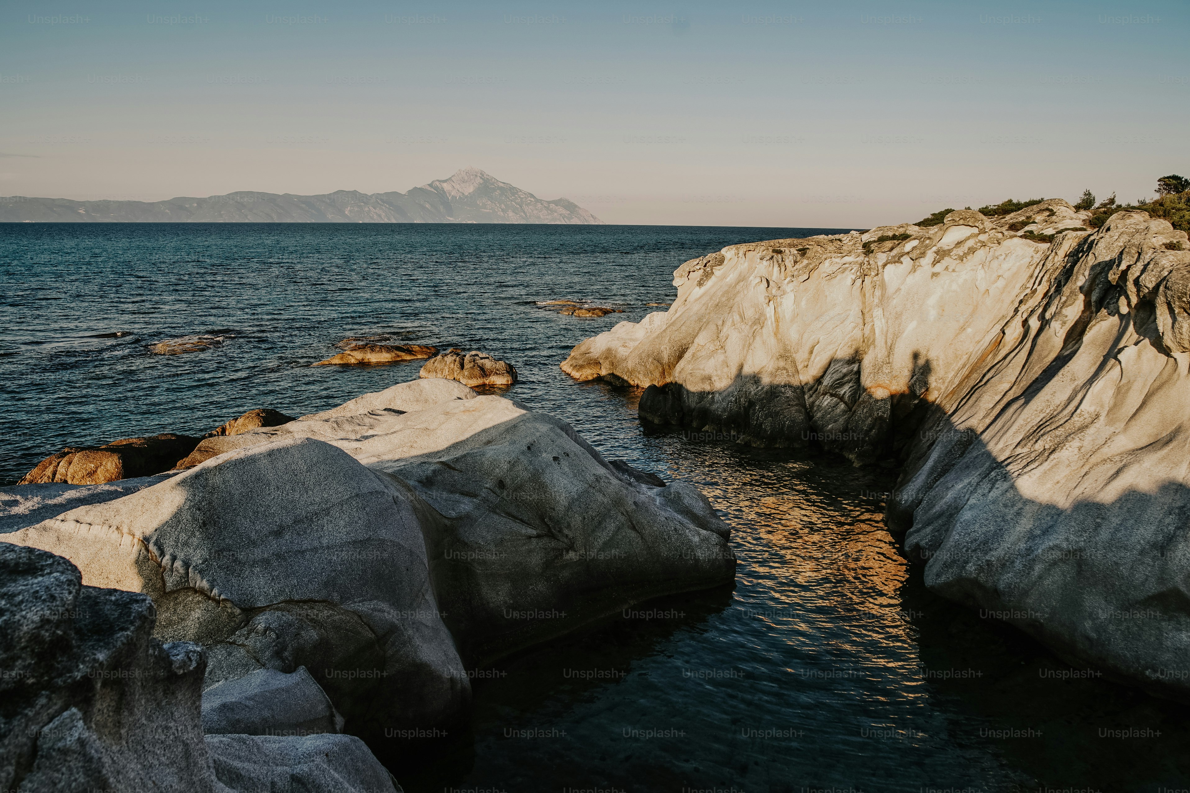 a rocky shore with a body of water