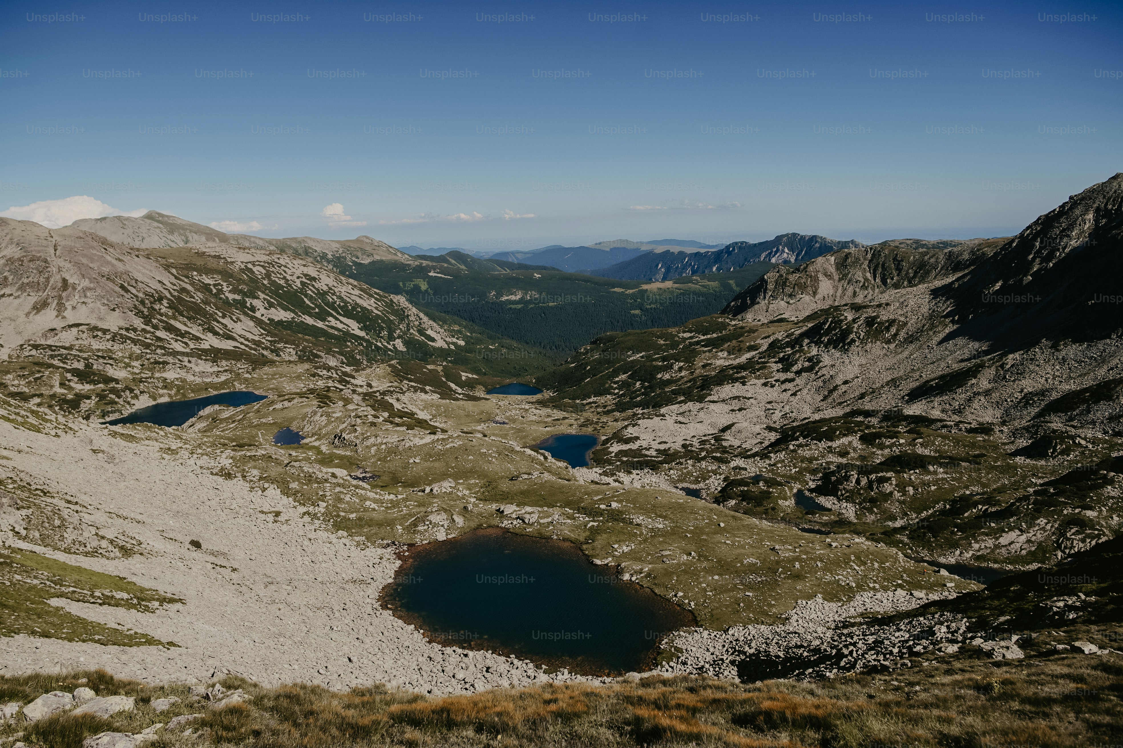 a view of a mountain range with a lake in the middle