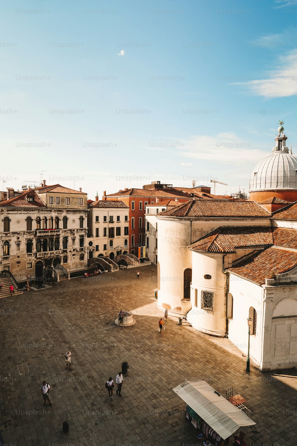 a group of people walking around a courtyard