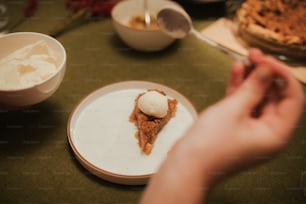 a slice of pie on a plate with a scoop of ice cream