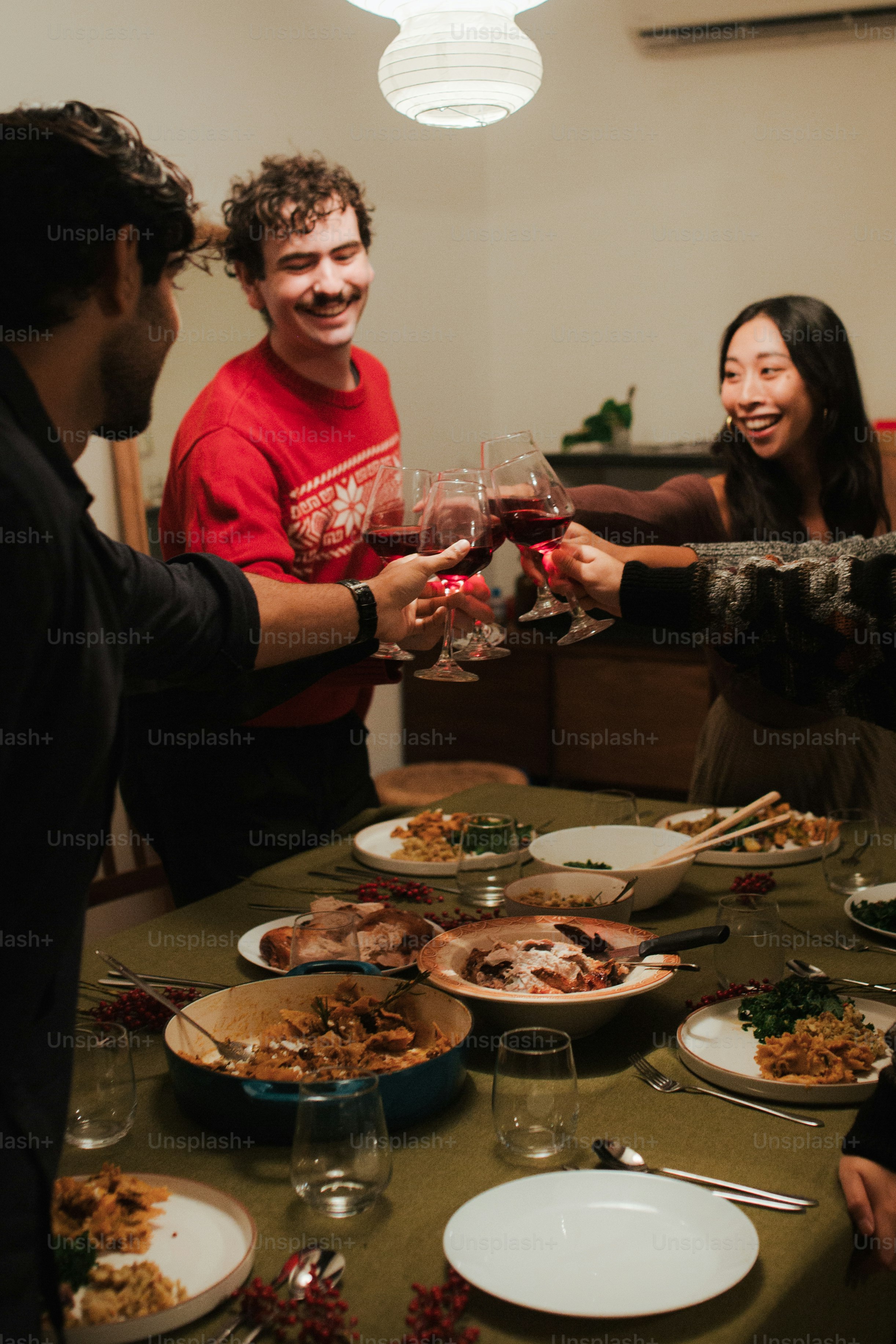 a group of people standing around a table full of food