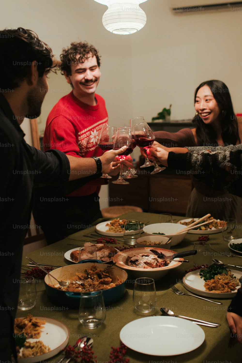 a group of people standing around a table full of food