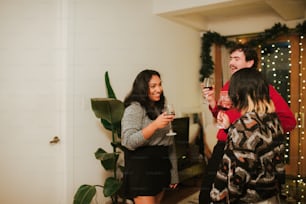 a group of people standing next to each other holding wine glasses