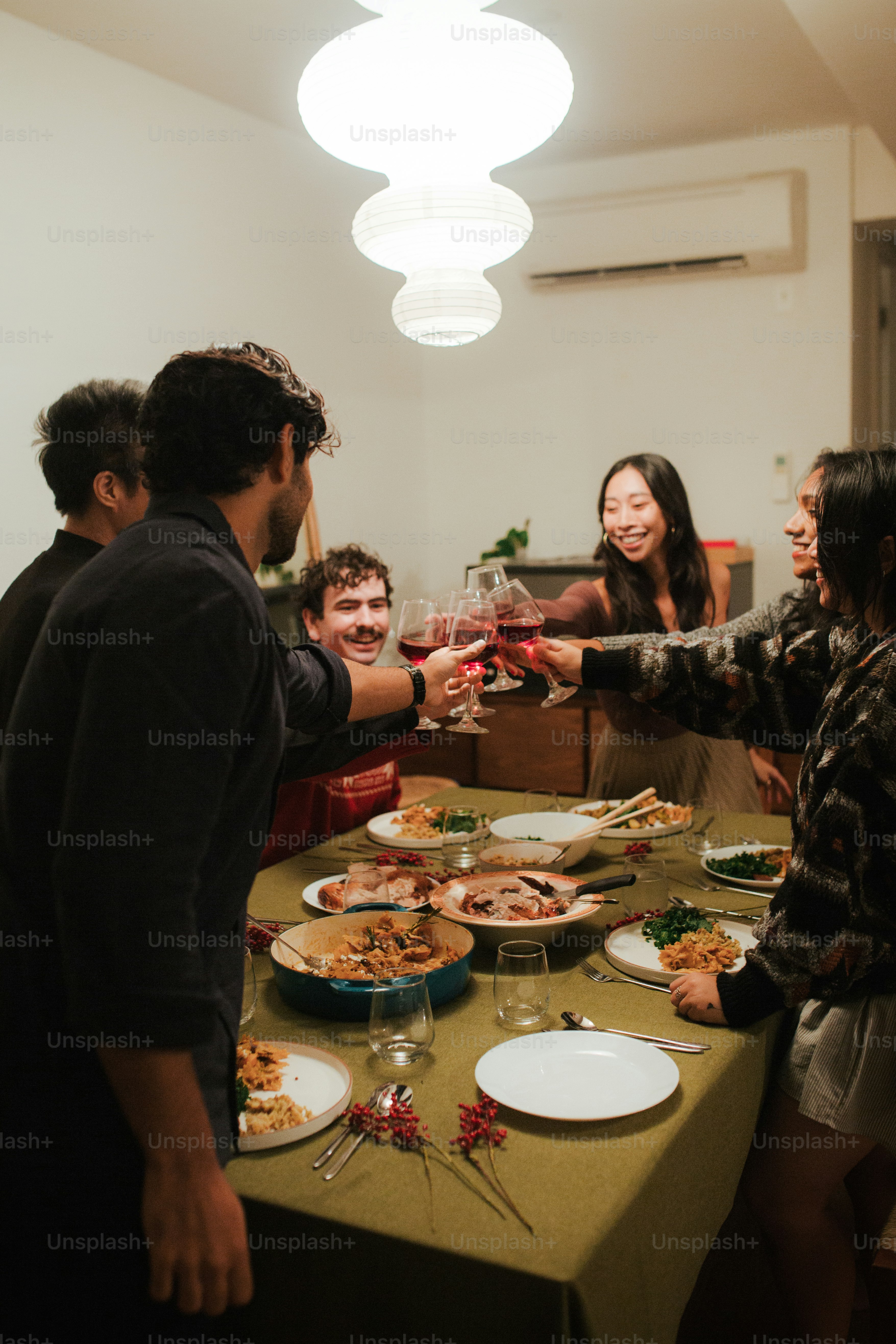 A group of people standing around a table drinking wine photo ...