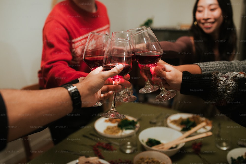 a group of people toasting with red wine