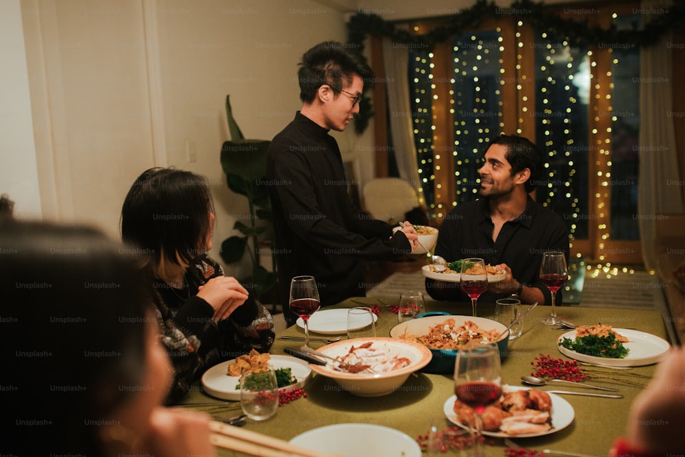 a group of people sitting around a dinner table