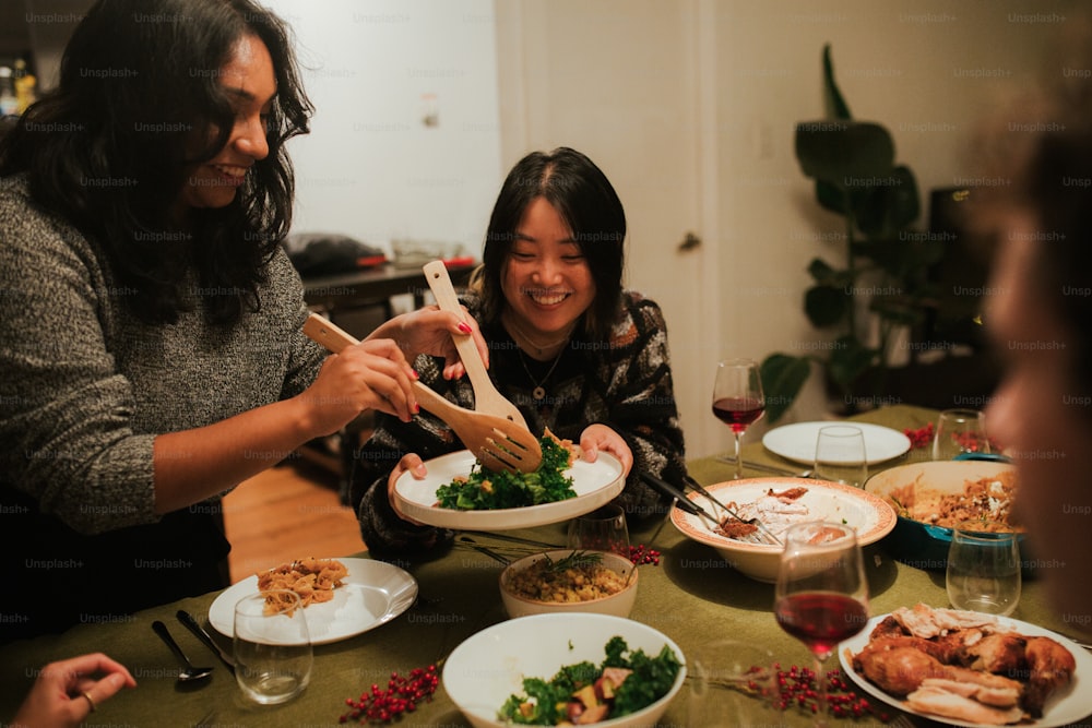 a group of people sitting around a table with plates of food