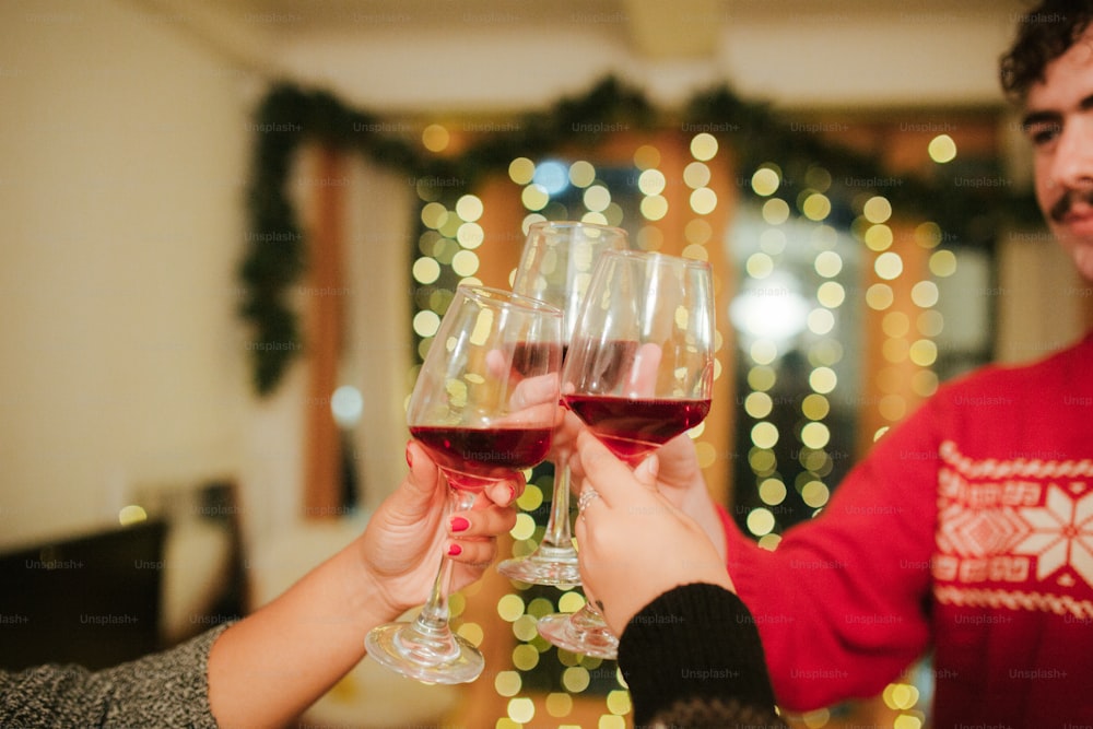 a man and a woman toasting with red wine