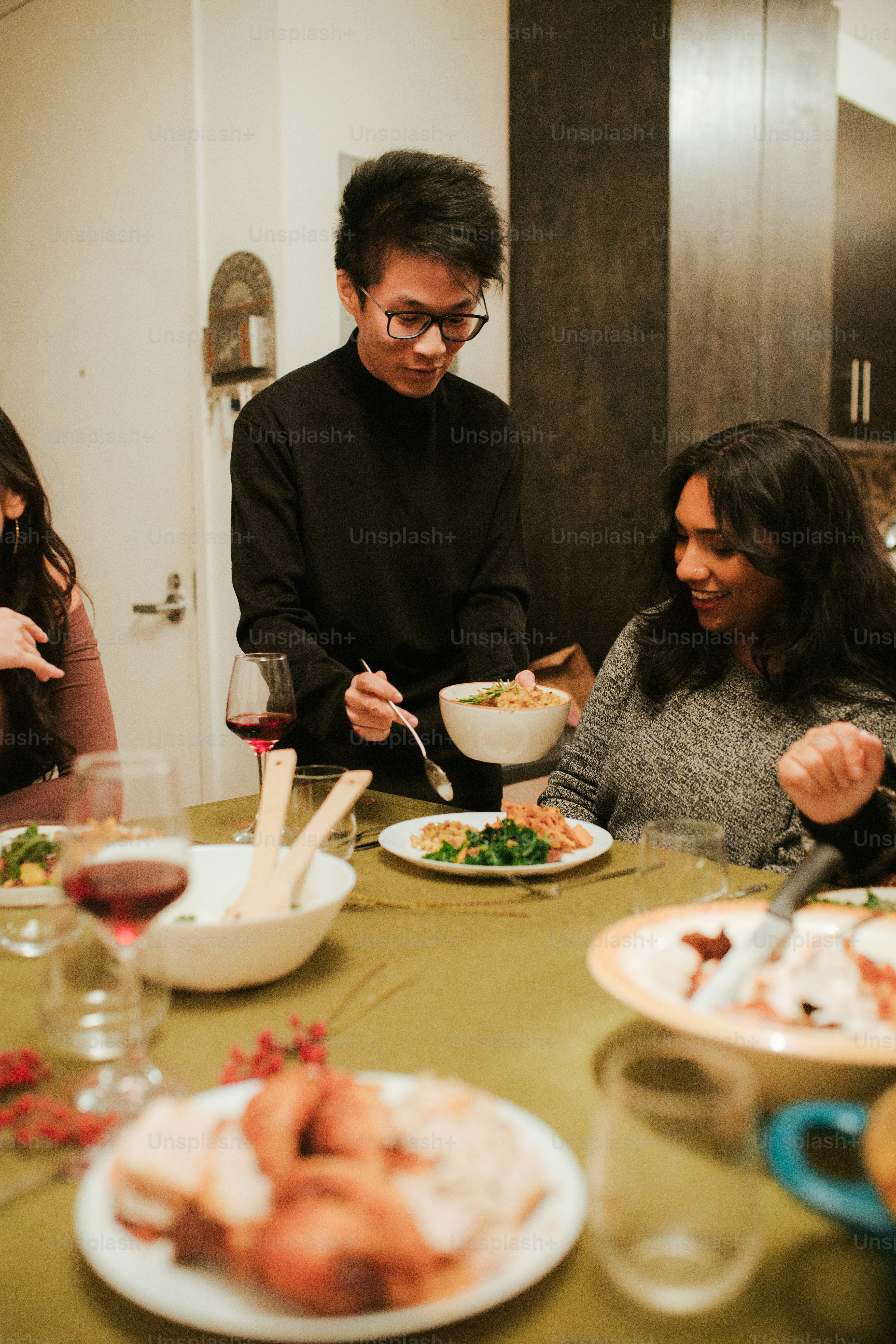 a group of people sitting around a table eating food