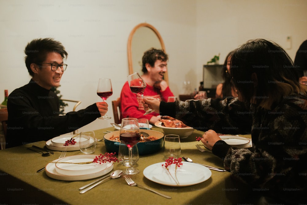 a group of people sitting around a table with plates of food