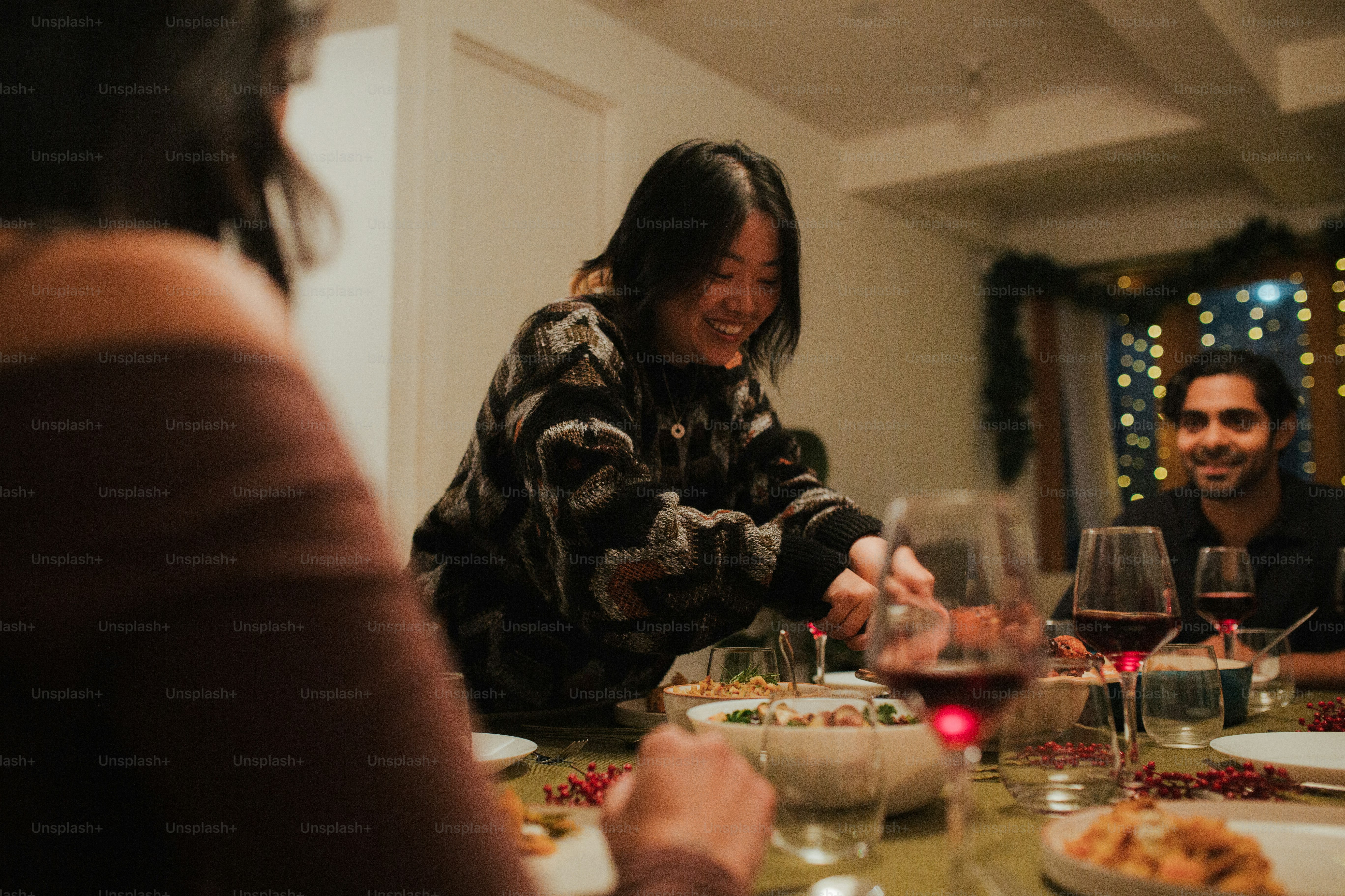 A group of people sitting around a table with wine glasses photo ...