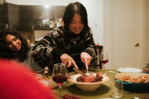 a woman cutting a piece of meat with a knife and fork