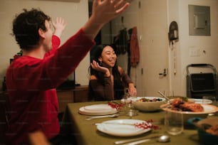 two people sitting at a table with plates of food