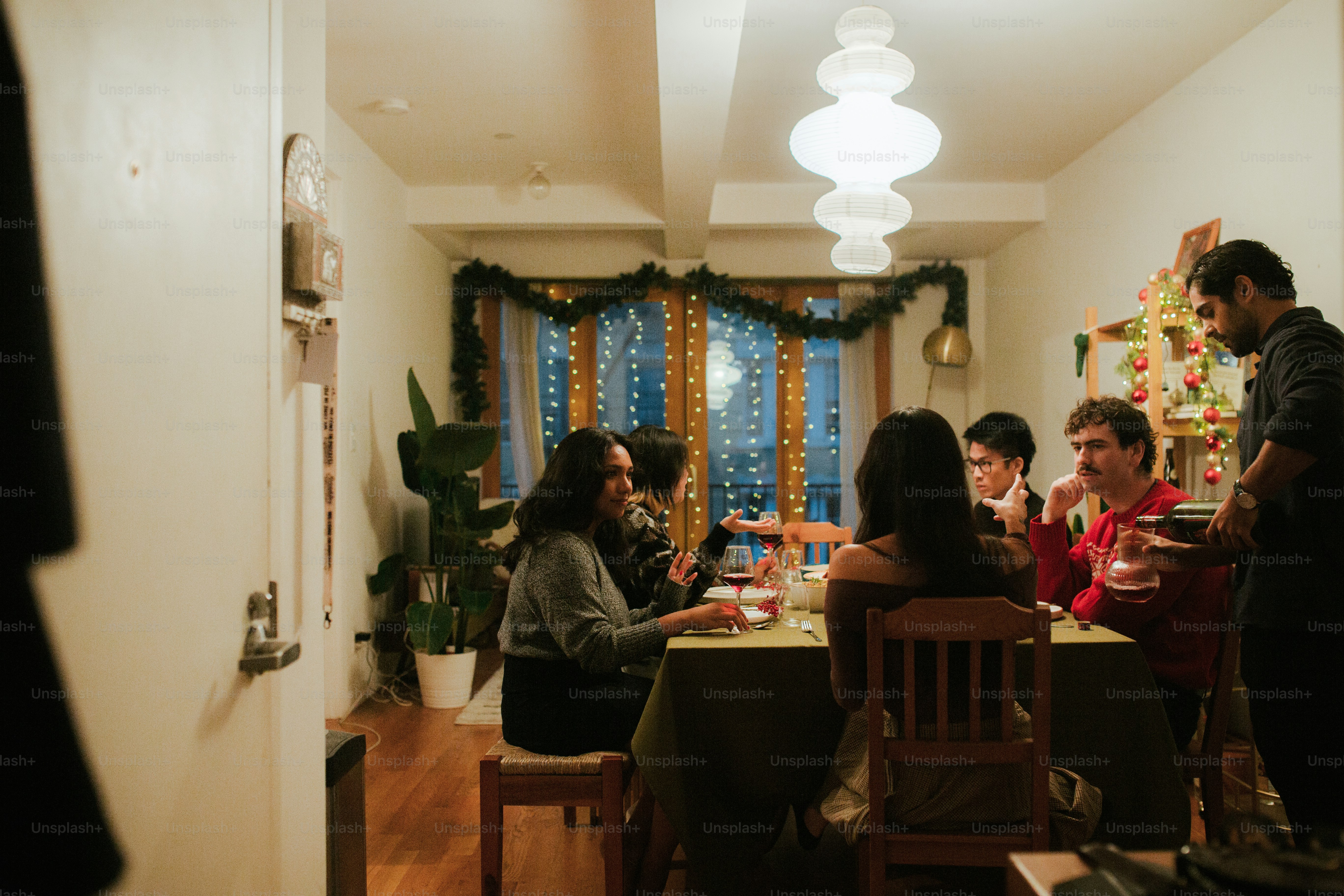 a group of people sitting around a dining room table