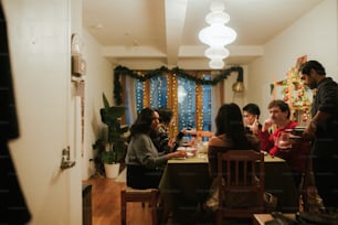 a group of people sitting around a dining room table