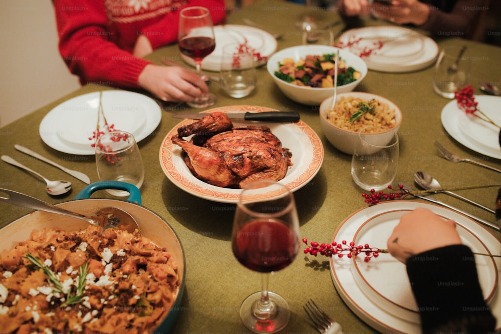 a group of people sitting around a table with plates of food