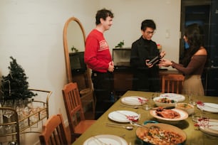 a group of people standing around a dining room table