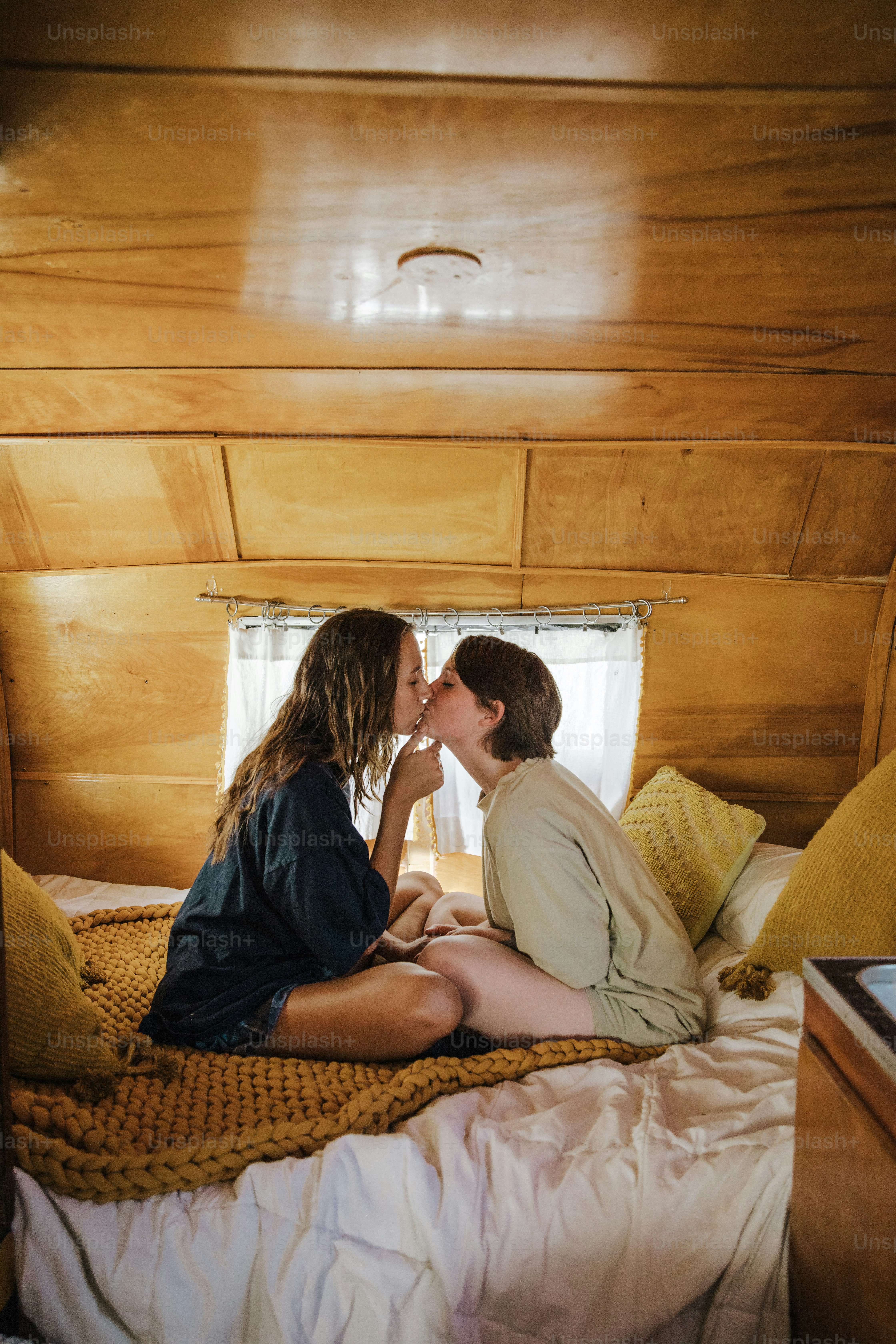 a couple of people sitting on top of a bed