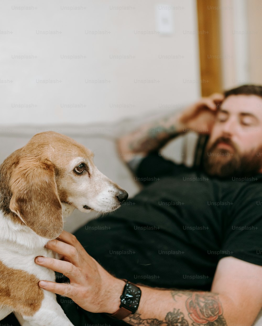 a man laying on a bed with a dog