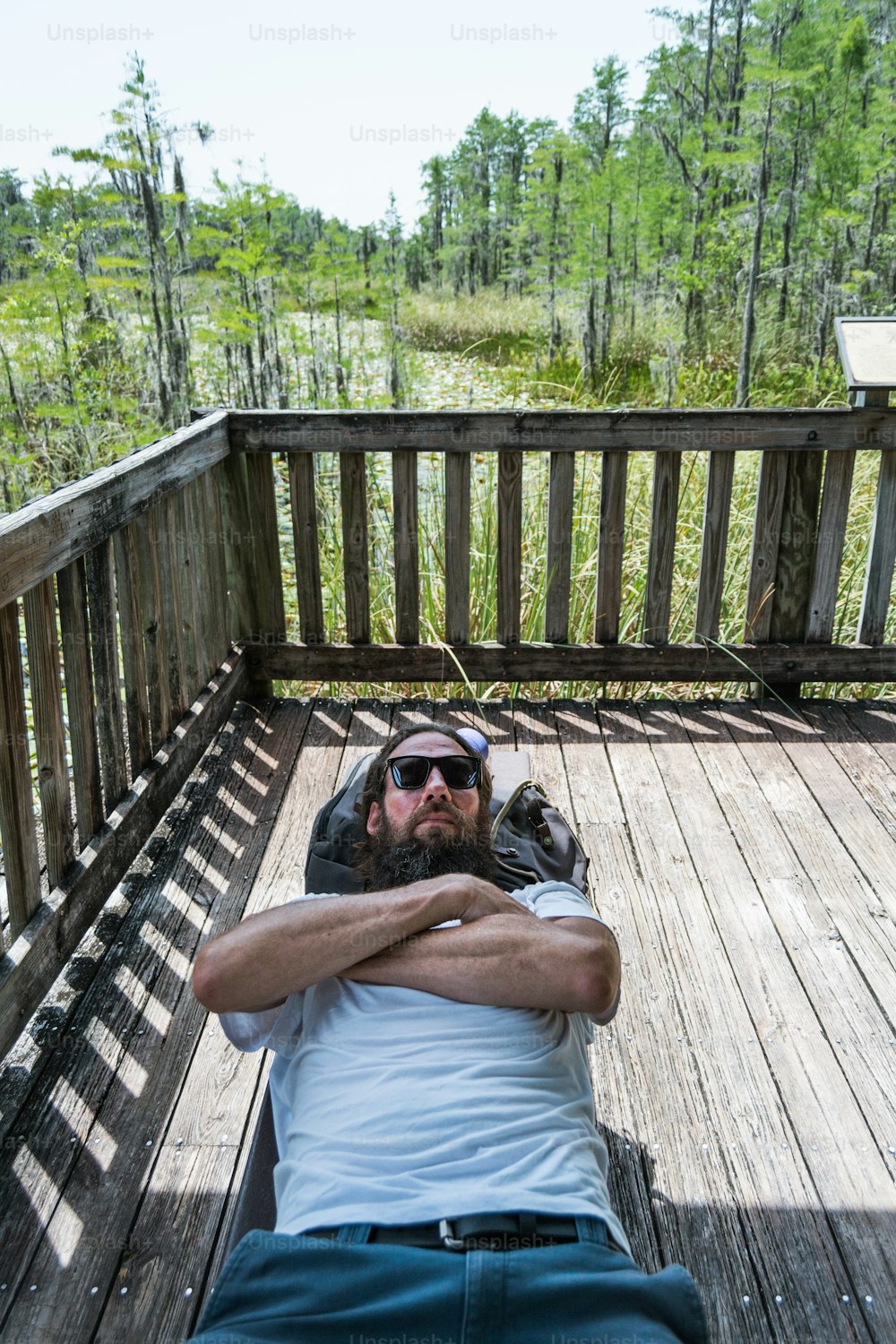 a man laying on top of a wooden deck