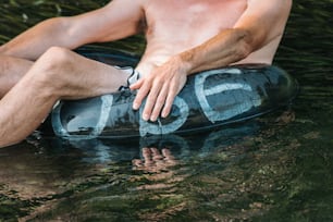 a man sitting on a boogie board in the water