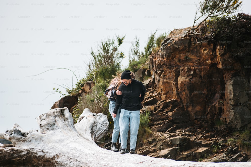 a couple of people that are standing in the snow