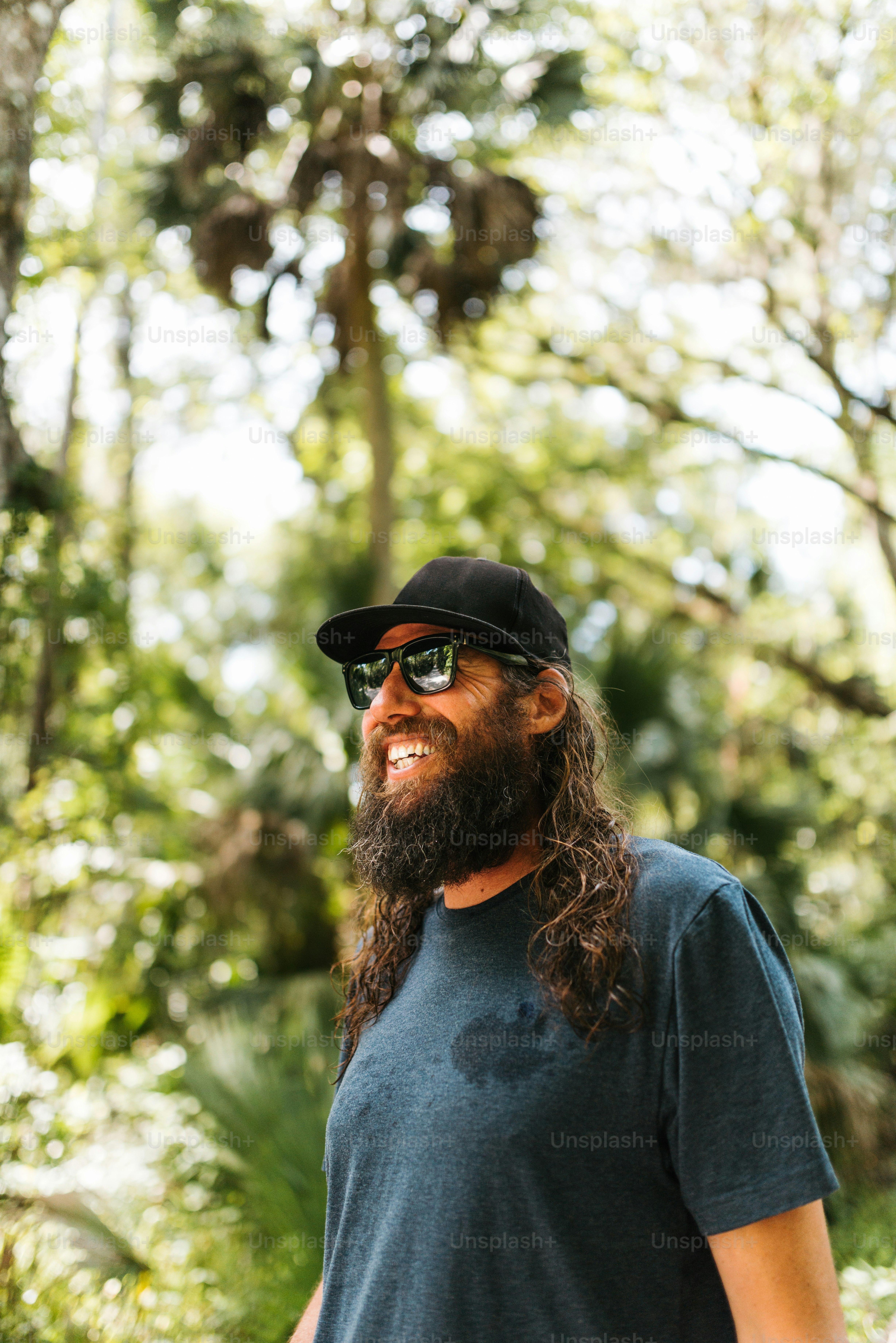 a man with long hair and a beard wearing sunglasses