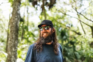 a man with long hair and a beard wearing sunglasses