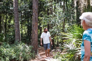 Ein Mann geht mit einem Koffer durch den Wald