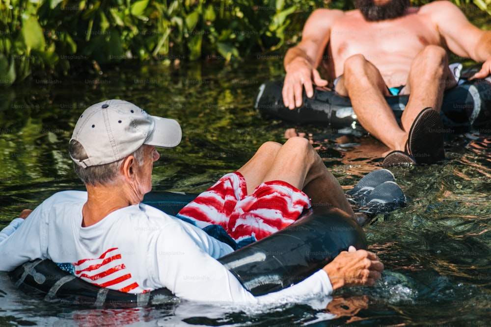 a man and a woman sitting on a raft in the water