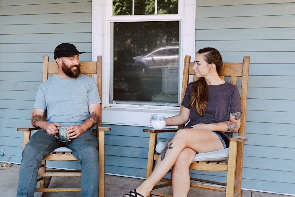 a man sitting next to a woman on a porch