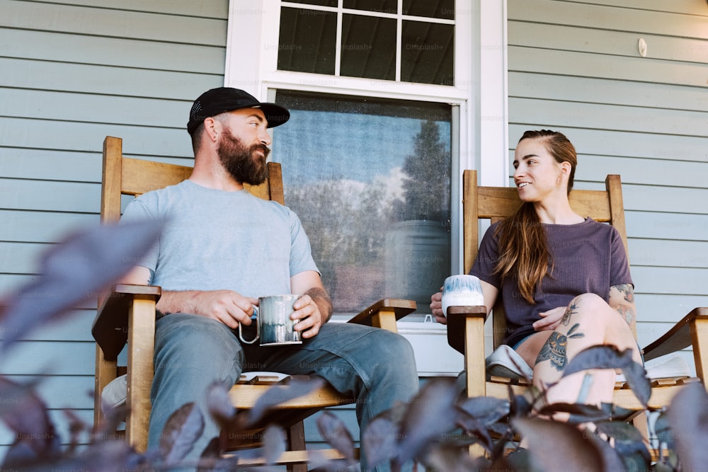 a man and a woman sitting on a porch
